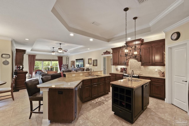 2926 Greystone Dr, Pace, FL 32571 - kitchen featuring a raised ceiling, an island with sink, a sink, open floor plan, and backsplash