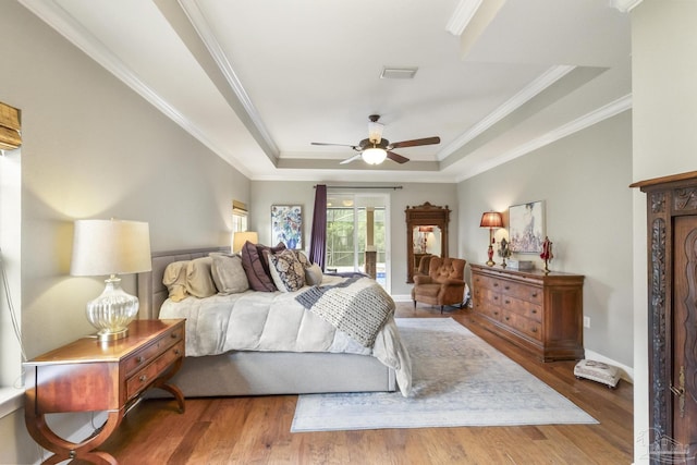 2926 Greystone Dr, Pace, FL 32571 - bedroom with a tray ceiling, access to outside, wood finished floors, crown molding, and a ceiling fan