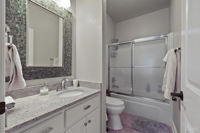2926 Greystone Dr, Pace, FL 32571 - bathroom with vanity, combined bath / shower with glass door, toilet, and tile patterned flooring