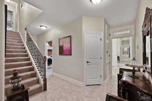 2926 Greystone Dr, Pace, FL 32571 - foyer featuring washer / clothes dryer, stairway, and light tile patterned flooring