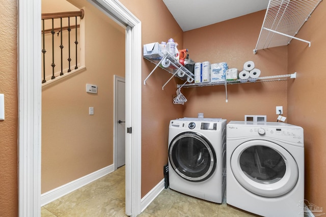 2926 Greystone Dr, Pace, FL 32571 - clothes washing area featuring washing machine and clothes dryer, baseboards, and tile patterned flooring