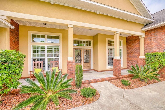 2926 Greystone Dr, Pace, FL 32571 - property entrance featuring stucco siding, a porch, and brick siding