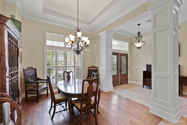 2926 Greystone Dr, Pace, FL 32571 - dining space with decorative columns, light wood finished floors, a chandelier, ornamental molding, and french doors