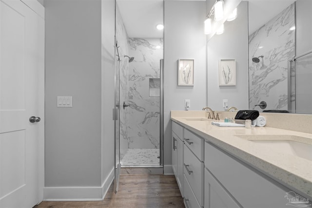 bathroom featuring walk in shower, vanity, and hardwood / wood-style floors