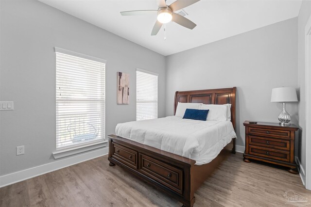 bedroom with ceiling fan and light hardwood / wood-style flooring