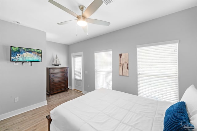 bedroom with light hardwood / wood-style floors and ceiling fan