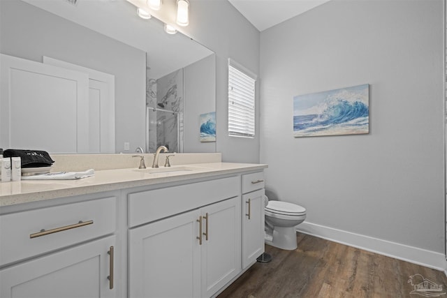 bathroom featuring wood-type flooring, vanity, toilet, and an enclosed shower