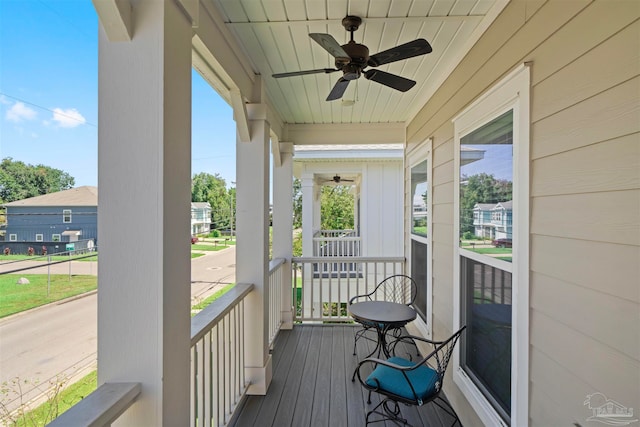 sunroom featuring wood ceiling, ceiling fan, and plenty of natural light