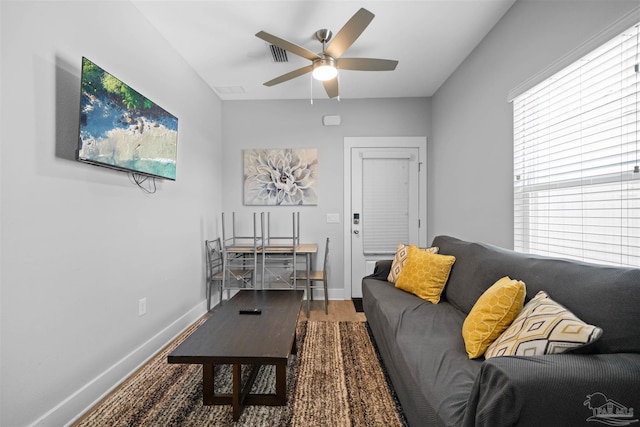 living room featuring hardwood / wood-style floors and ceiling fan