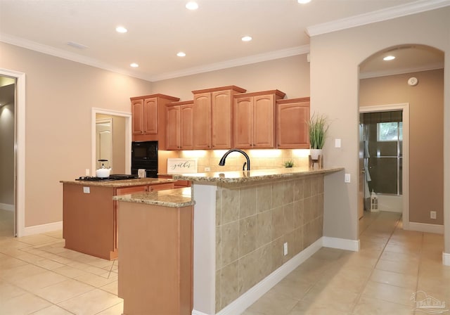 4436 Soundside Dr, Gulf Breeze, FL 32563 - kitchen with light tile patterned flooring, tasteful backsplash, a peninsula, light stone counters, and recessed lighting