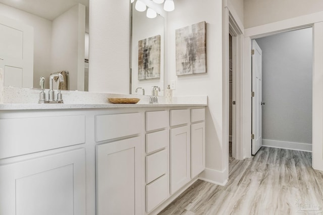 4680 Eider Rd, Pace, FL 32571 - bathroom with double vanity and wood finished floors