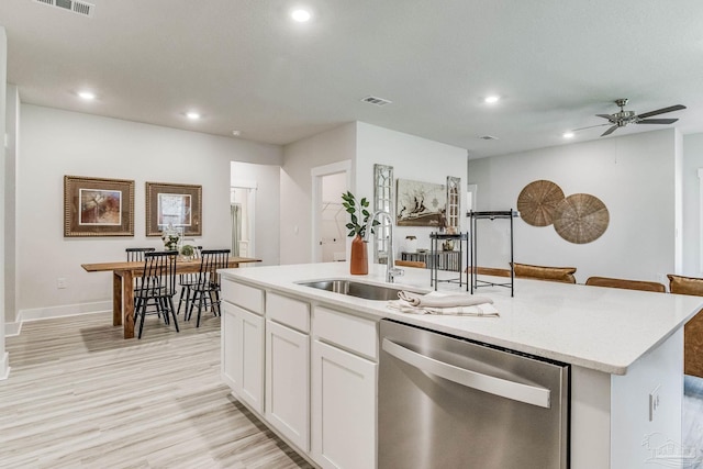 4680 Eider Rd, Pace, FL 32571 - kitchen featuring dishwasher, a kitchen island with sink, recessed lighting, light wood-style floors, and white cabinets