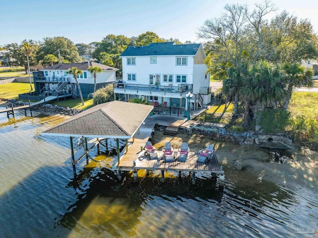 view of dock featuring a deck with water view, boat lift, and stairs