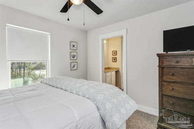 bedroom with ensuite bath, ceiling fan, and carpet