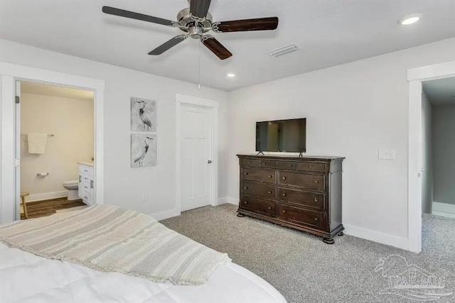 bedroom featuring ensuite bath, ceiling fan, and light colored carpet