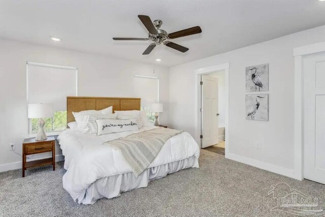 carpeted bedroom featuring ensuite bathroom and ceiling fan