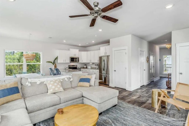 living room featuring dark hardwood / wood-style floors and ceiling fan