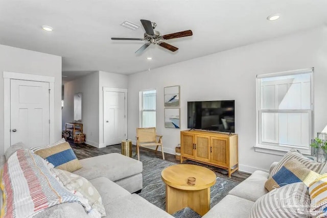 living room with ceiling fan and dark hardwood / wood-style flooring