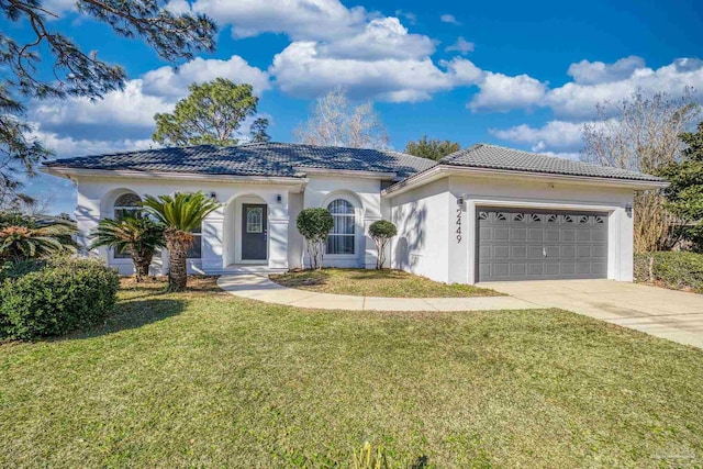 mediterranean / spanish-style home with a front lawn and a garage