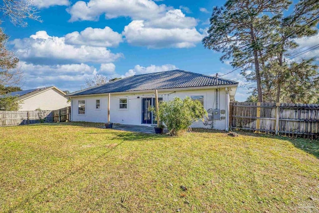 rear view of house with a lawn