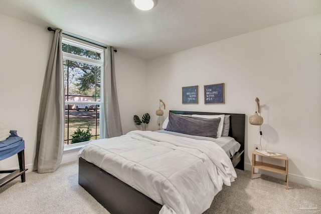 carpeted bedroom featuring baseboards