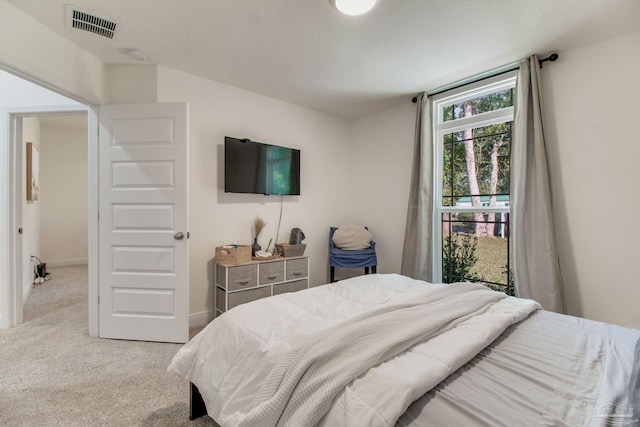 bedroom featuring baseboards, visible vents, and light carpet