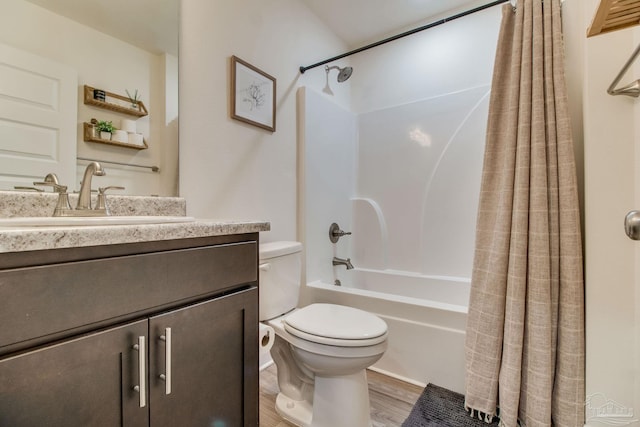 full bath featuring shower / tub combo with curtain, toilet, vanity, and wood finished floors