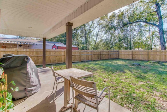 view of patio / terrace featuring a grill, a fenced backyard, and outdoor dining space