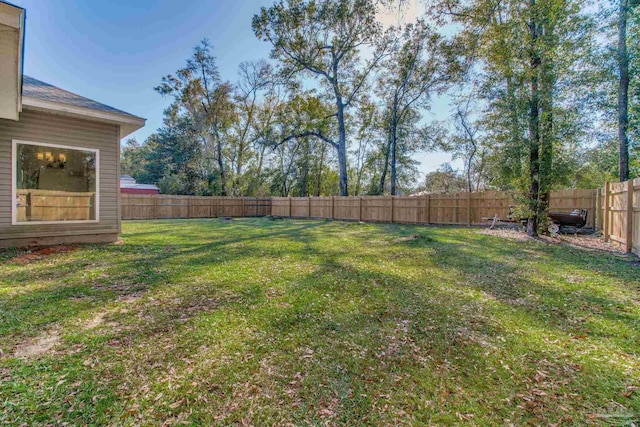 view of yard with a fenced backyard