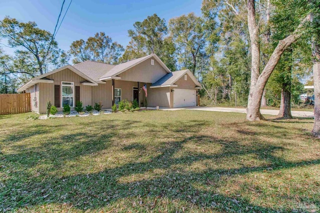 single story home featuring a front lawn, an attached garage, fence, and concrete driveway