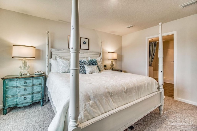 bedroom with a textured ceiling, carpet, visible vents, and baseboards