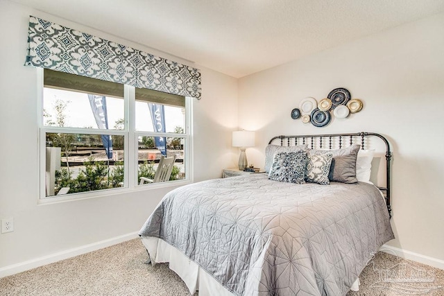 carpeted bedroom with baseboards