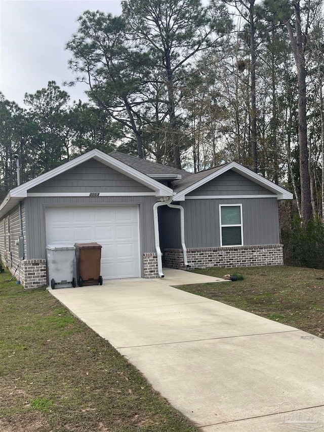 single story home featuring a garage and a front lawn