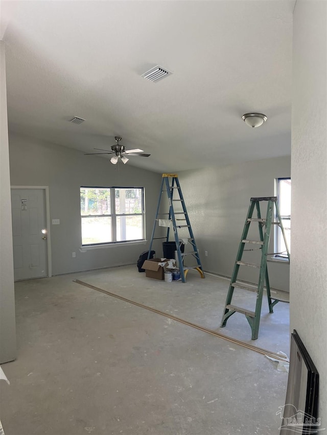 interior space with lofted ceiling and ceiling fan