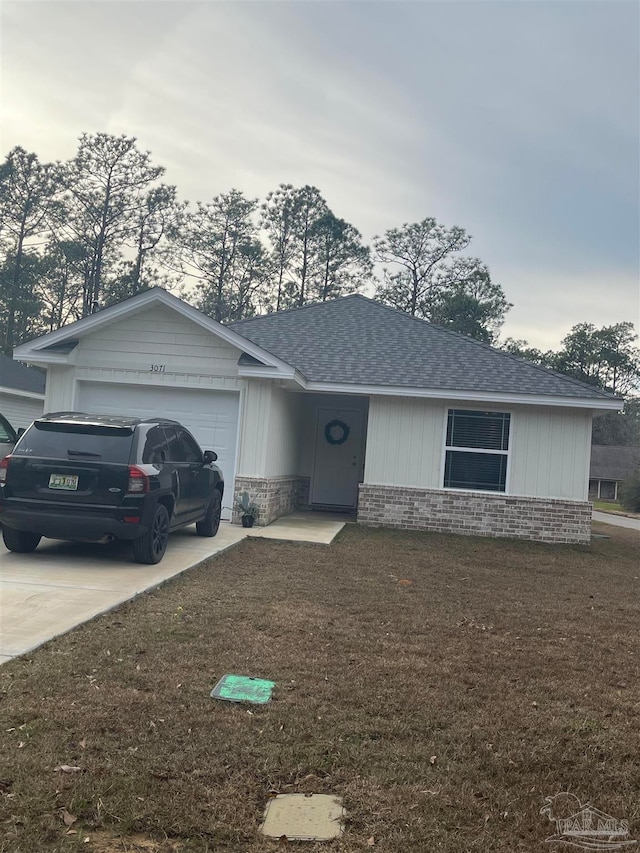 ranch-style house featuring a garage and a front yard