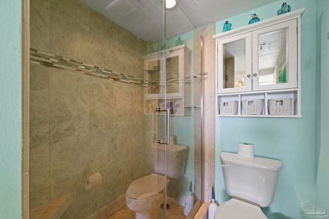 bathroom with a shower with shower door and toilet