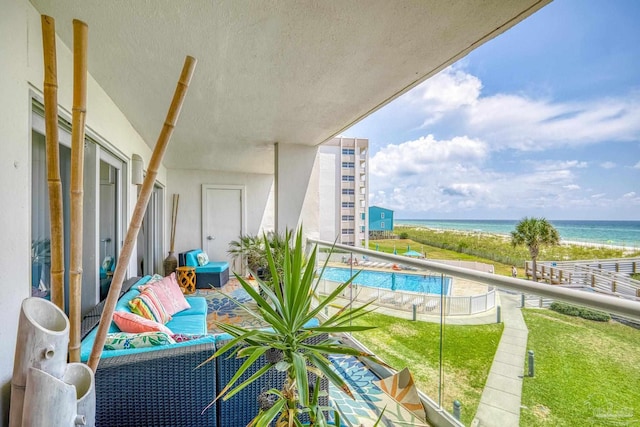 balcony with a water view and a pool