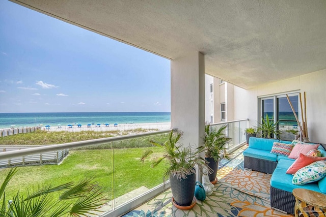 balcony with an outdoor living space and a water view