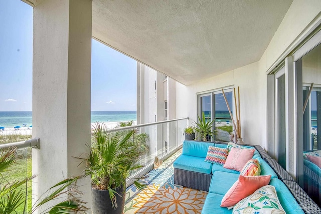 balcony featuring an outdoor living space and a water view