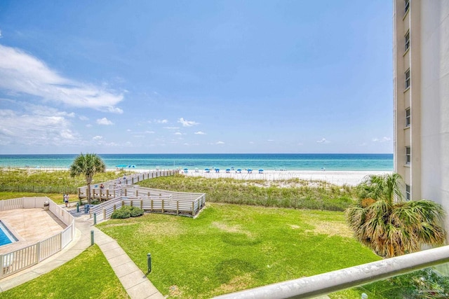 view of water feature featuring fence and a view of the beach