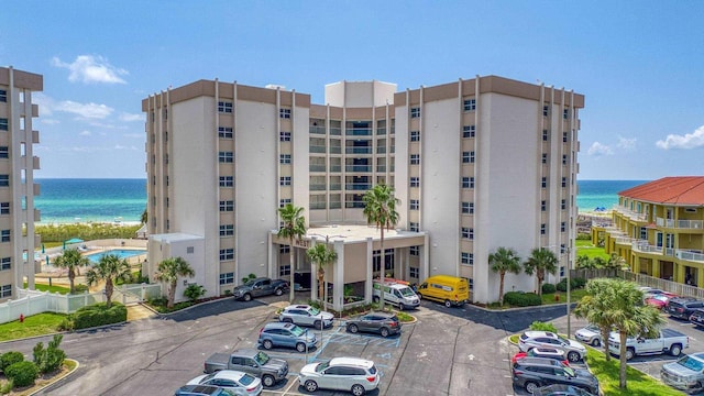 view of property featuring a water view and uncovered parking