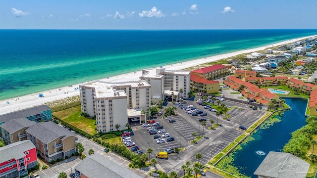 birds eye view of property featuring a beach view and a water view