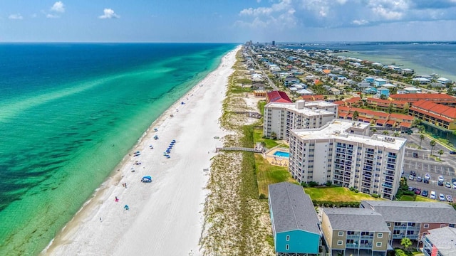 birds eye view of property featuring a water view and a beach view