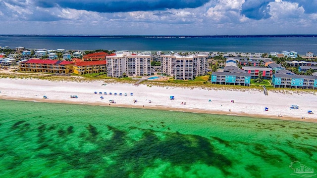 drone / aerial view featuring a beach view and a water view