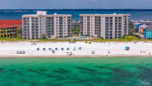 drone / aerial view featuring a view of the beach and a water view