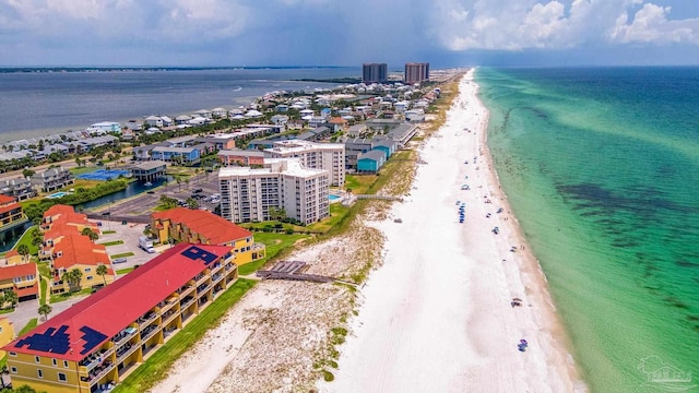 drone / aerial view featuring a water view and a view of the beach