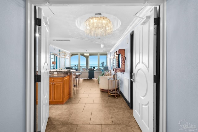 5 Portofino Dr Unit 703, Pensacola Beach, FL 32561 - hall with a chandelier, light tile patterned floors, ornamental molding, and a textured wall