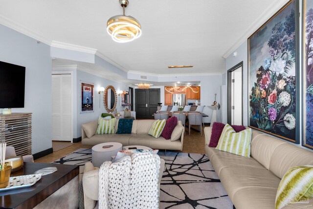 5 Portofino Dr Unit 703, Pensacola Beach, FL 32561 - living room featuring a chandelier and crown molding