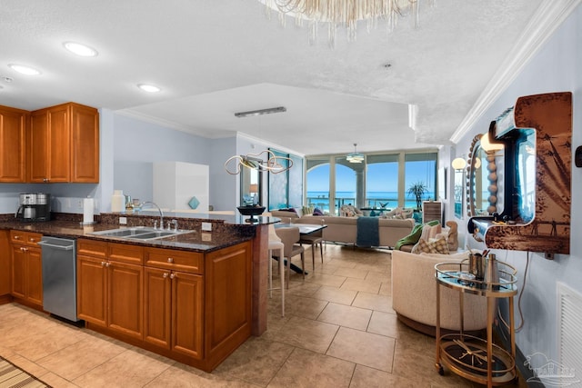 5 Portofino Dr Unit 703, Pensacola Beach, FL 32561 - kitchen with stainless steel dishwasher, brown cabinets, crown molding, open floor plan, and dark stone counters