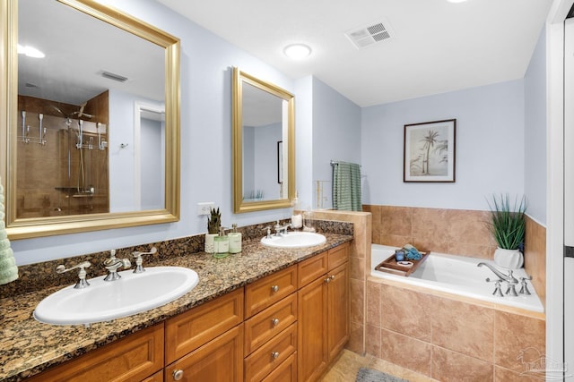 5 Portofino Dr Unit 703, Pensacola Beach, FL 32561 - full bathroom with a bath, double vanity, a stall shower, and tile patterned flooring